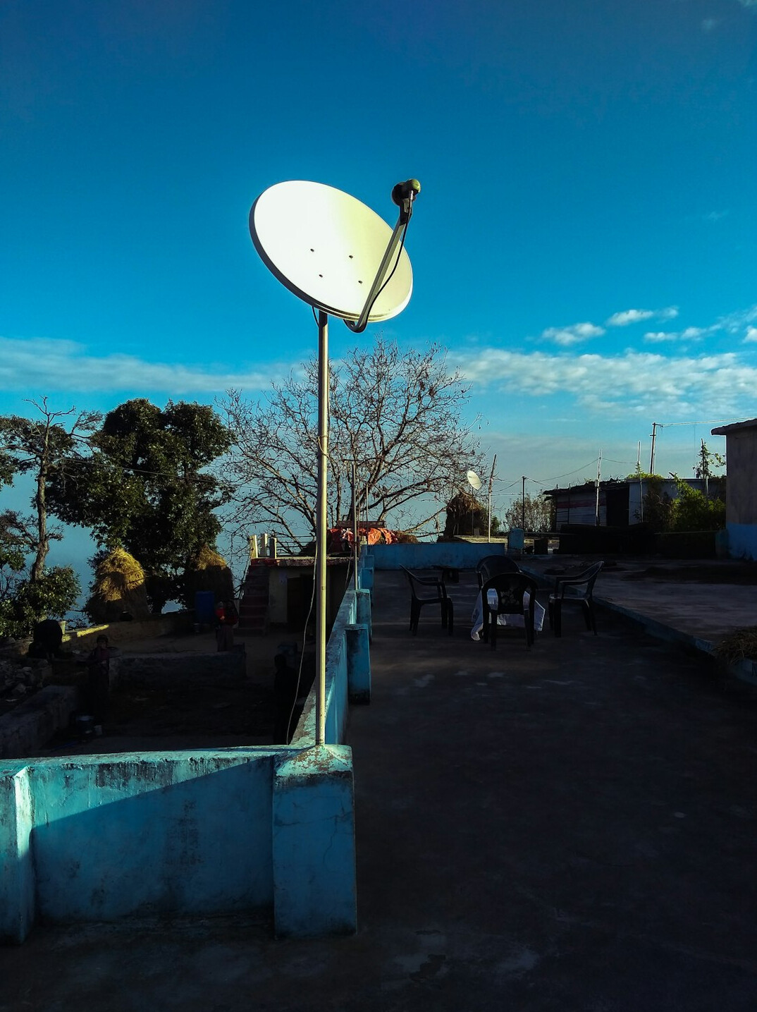Satellite uplink dish transmitting a live broadcast signal