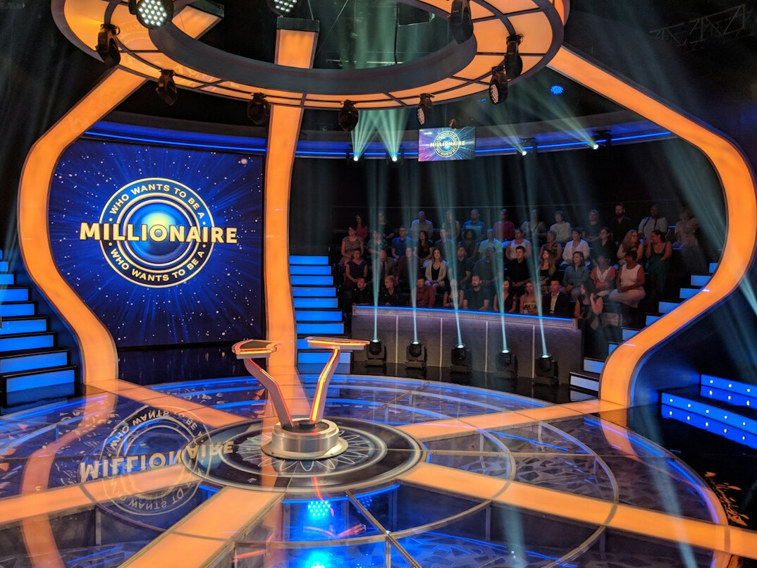 Diverse team of broadcast professionals working together in a television studio